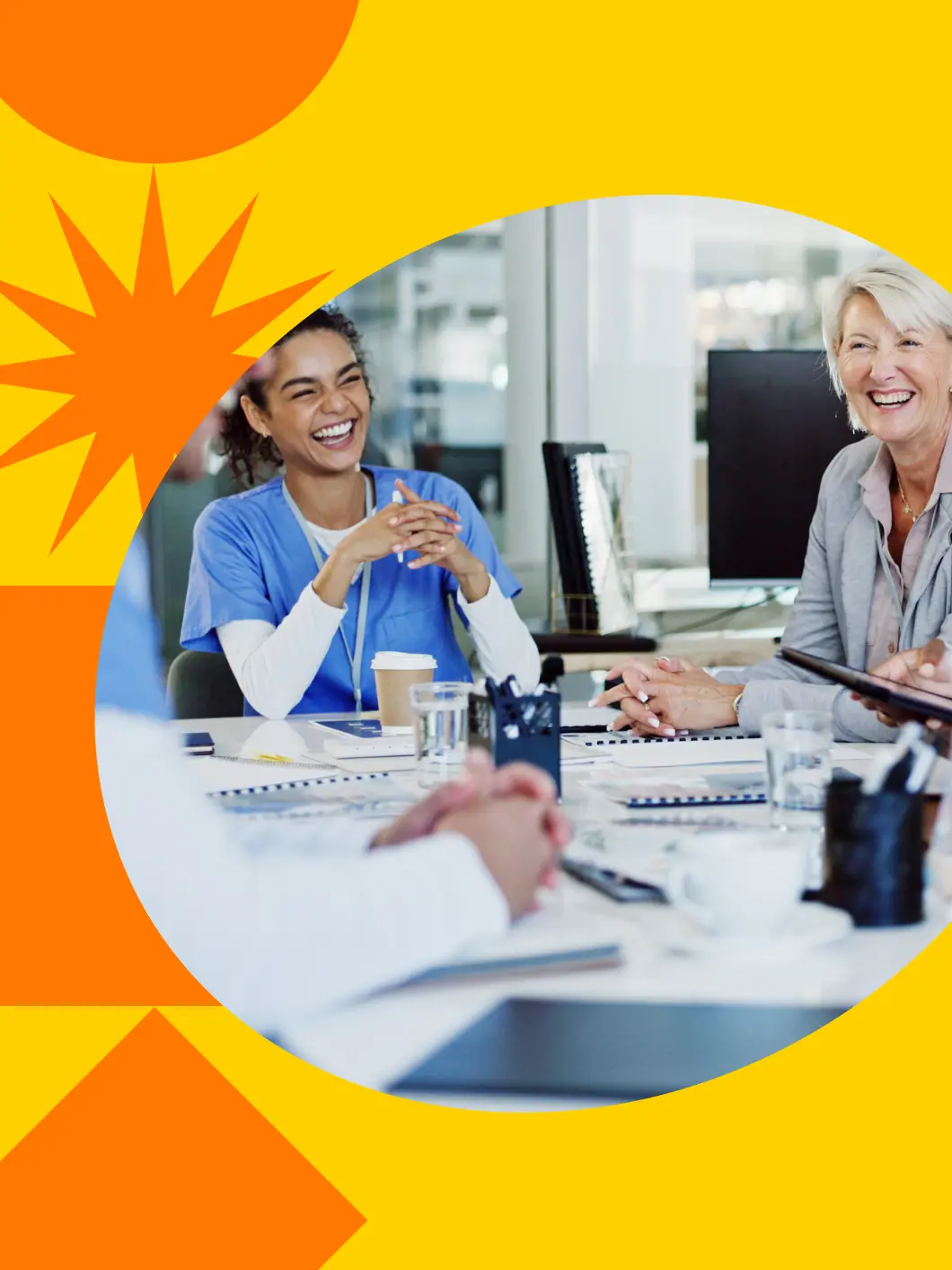 Colleagues sharing a laugh together at a meeting table